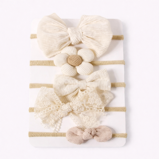 Set of baby hairbands with various designs on a white background