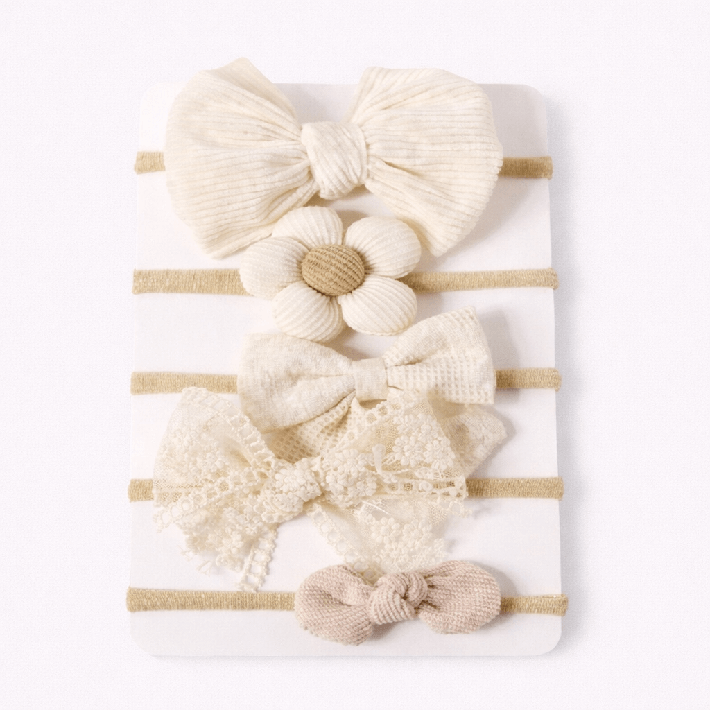 Set of baby hairbands with various designs on a white background