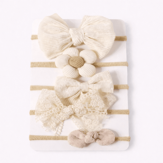 Set of baby hairbands with various designs on a white background