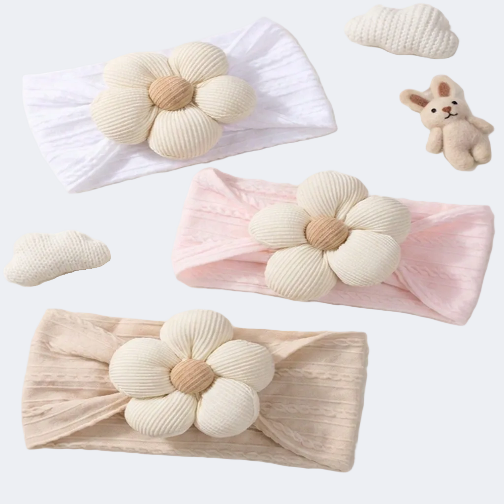 Three headbands with floral designs in white, pink, and beige on a white background.