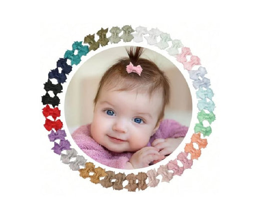 Baby with colorful hair bows arranged in a circular pattern