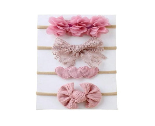 Set of pink hair accessories including flowers, bows, and hearts